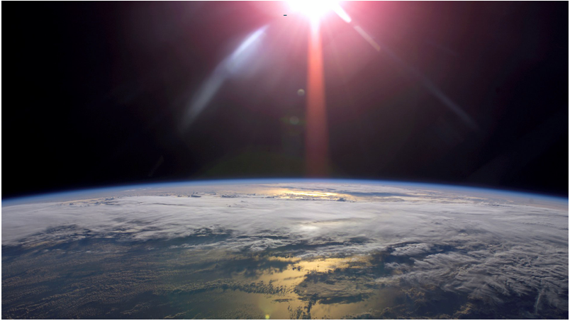 Space view of Earth with the Sun on the horizon