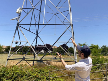 Man looking at power lines