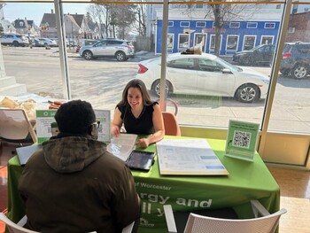 City staff helping a resident at a table